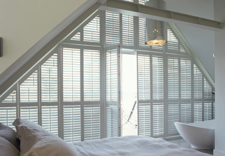 White, special shaped shutters to cover large, unusual window shape