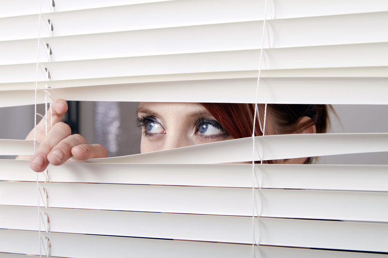 women looking through blinds