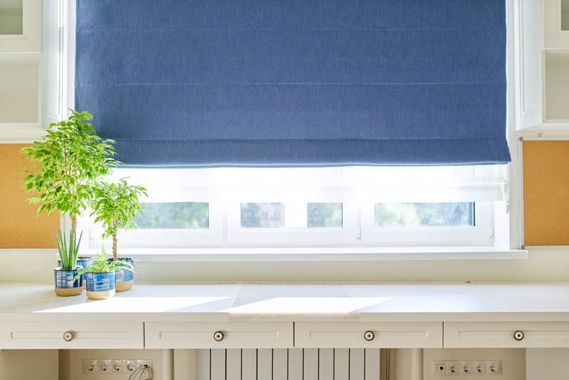 Blue coloured, fabric heat insulated roman blinds